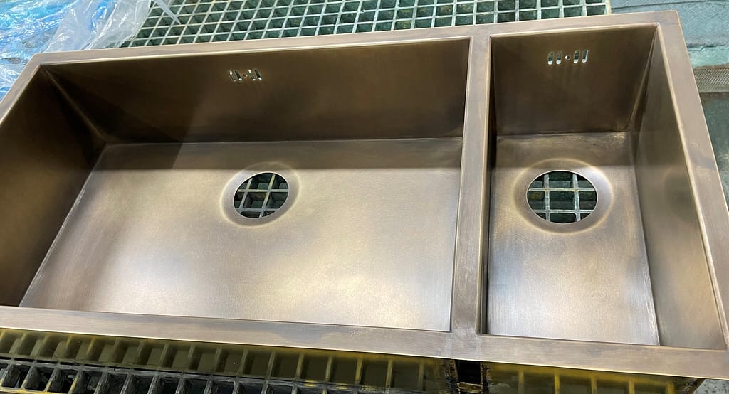 Antique Brass Double Bowl Undermount Sink - Designs 05 Antique brass double bowl undermount sink in the workshop, showcasing its hand-aged patina.