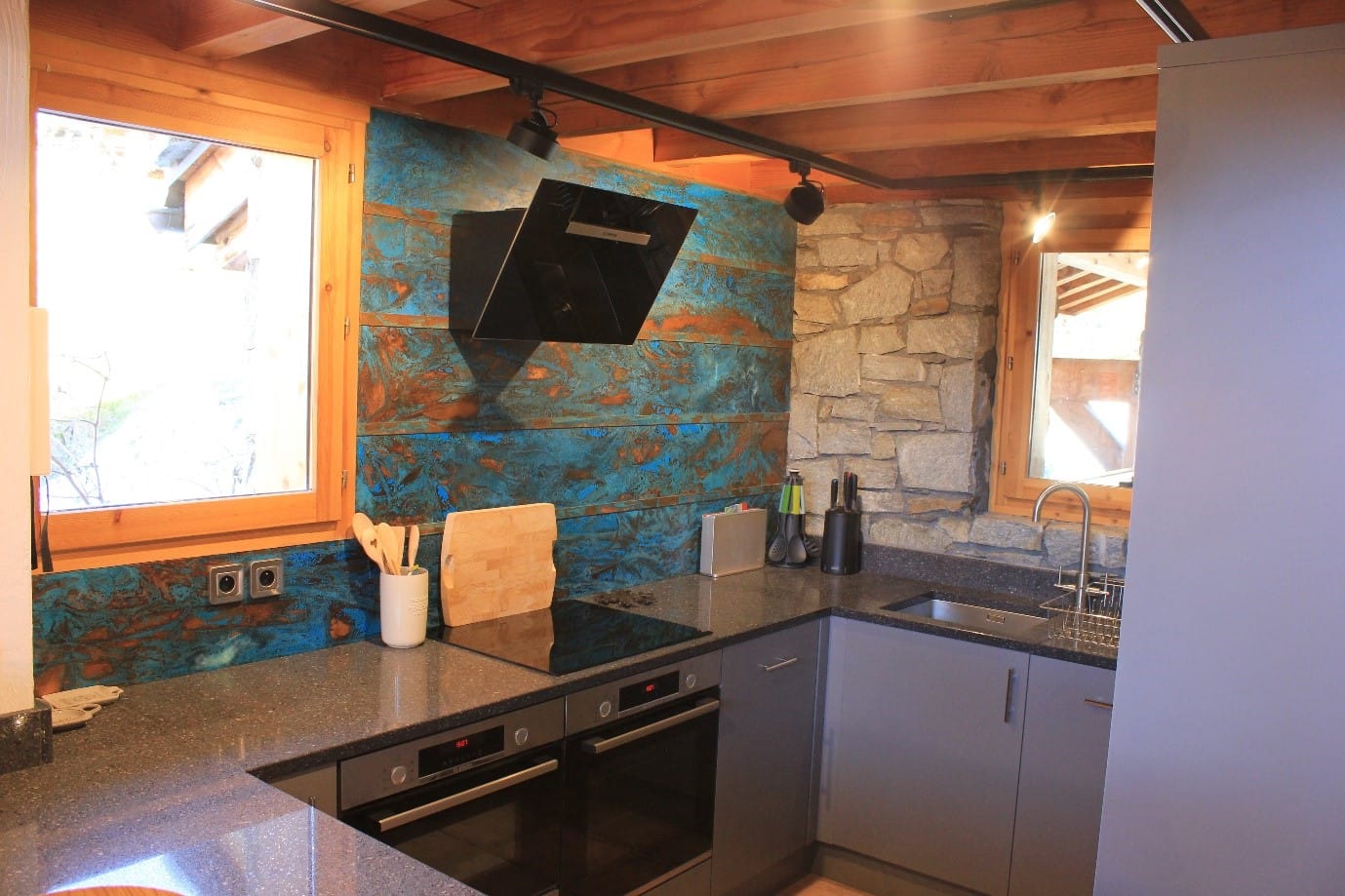 Blue Patina Copper Wall Cladding with a Rustic Timber & Stone Finish - Designs 05 Blue patina copper wall panels in rustic kitchen with timber and natural stone.