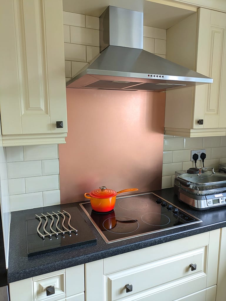 Satin Copper Kitchen Splashback - Designs 05 Satin copper splashback, adding a soft metallic sheen to a contemporary kitchen with minimalist cabinetry.